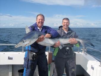 104 lb Blue Shark by Kevin (on the Right)
