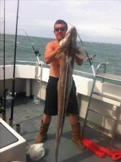 38 lb Conger Eel by neil phat cat crew member / skipper holding fish